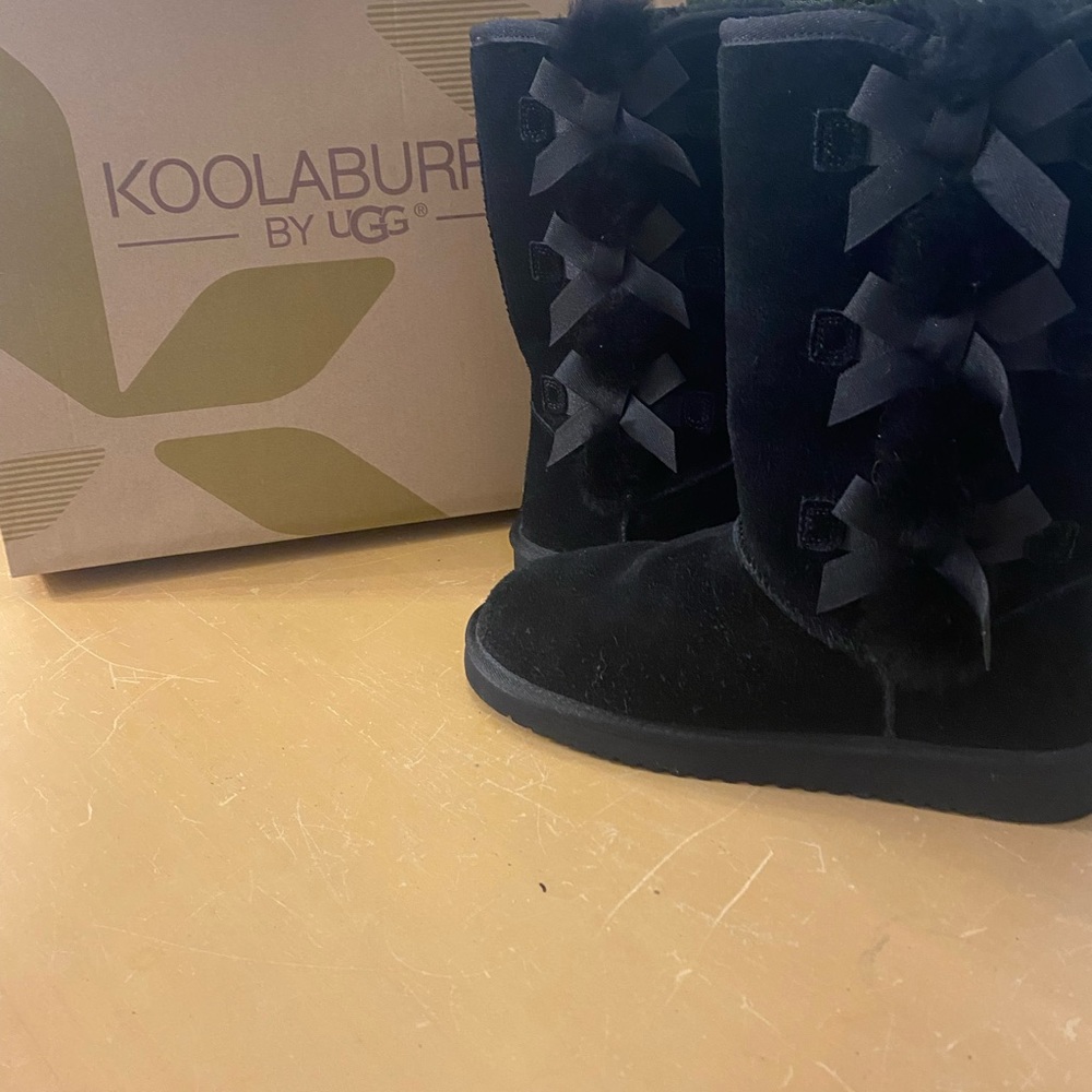 Kookaburra boots by UGG.  Black boots with 3 bows down the side.